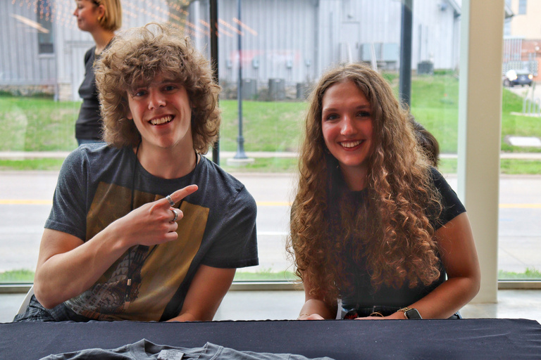 Two students sit at a table as part of the Iowa City Documentary Film Festival.