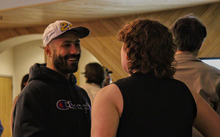 Filmmaker Khalik Allah speaking to a student at the Iowa City Documentary Film Festival.