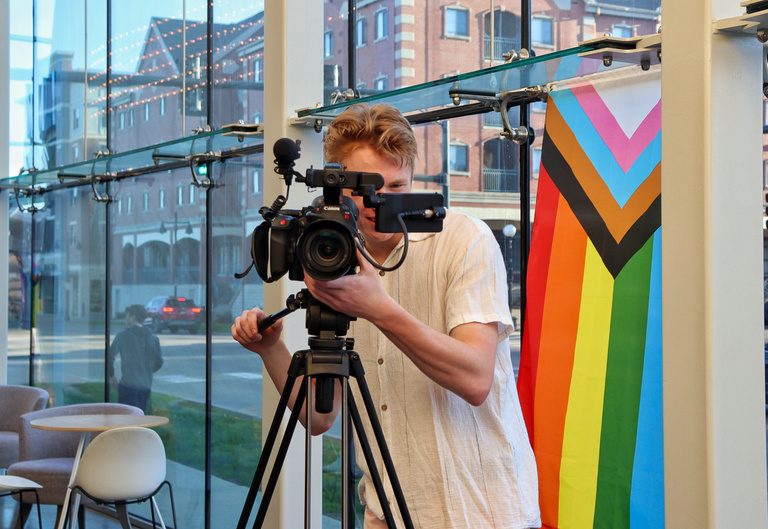 Student behind a camera at the Iowa City Documentary Film Festival.