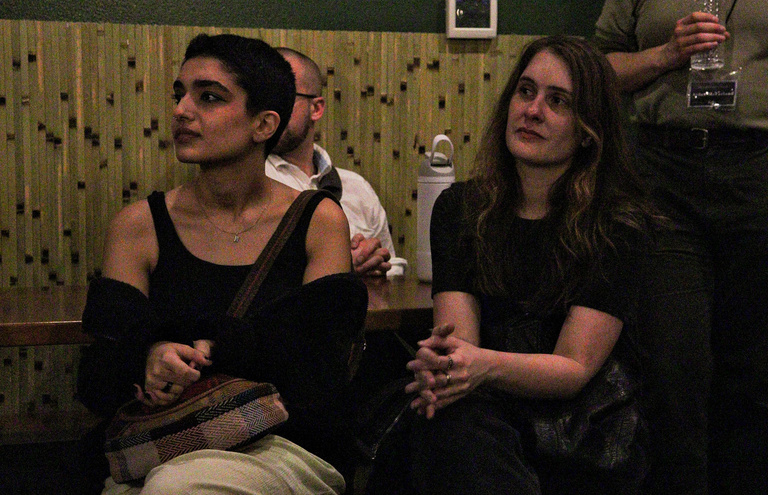 A student and Cinematic Arts profess, Kate Hinshaw, sitting next to each other at the Iowa City Documentary Film Festival closing event held at The Green House.