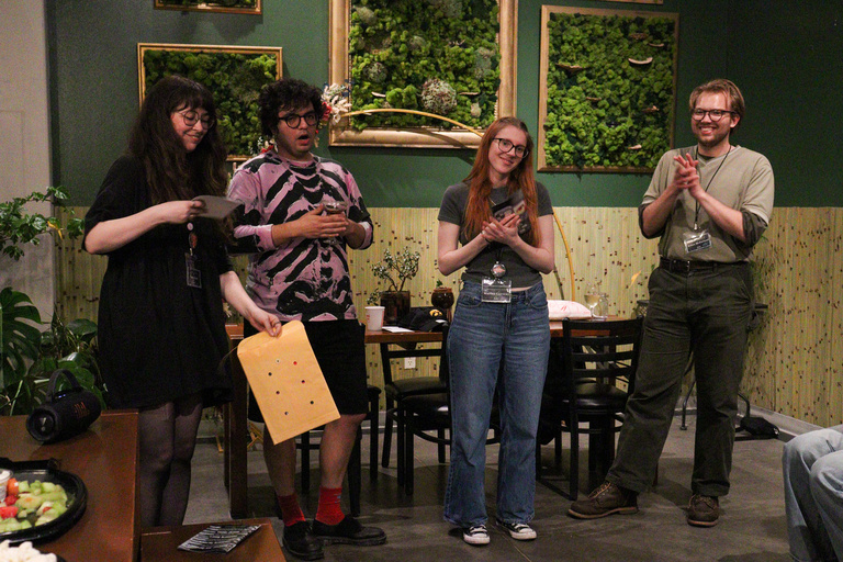 Cinematic Arts professor and ICDOCS director, Laura Gede, and three students standing at the Iowa City Documentary Film Festival's closing ceremony in The Green House.